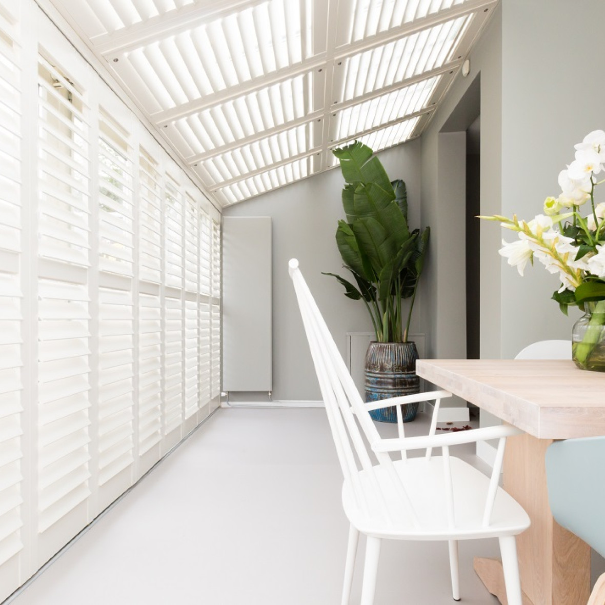 Witte JASNO shutters in een serre